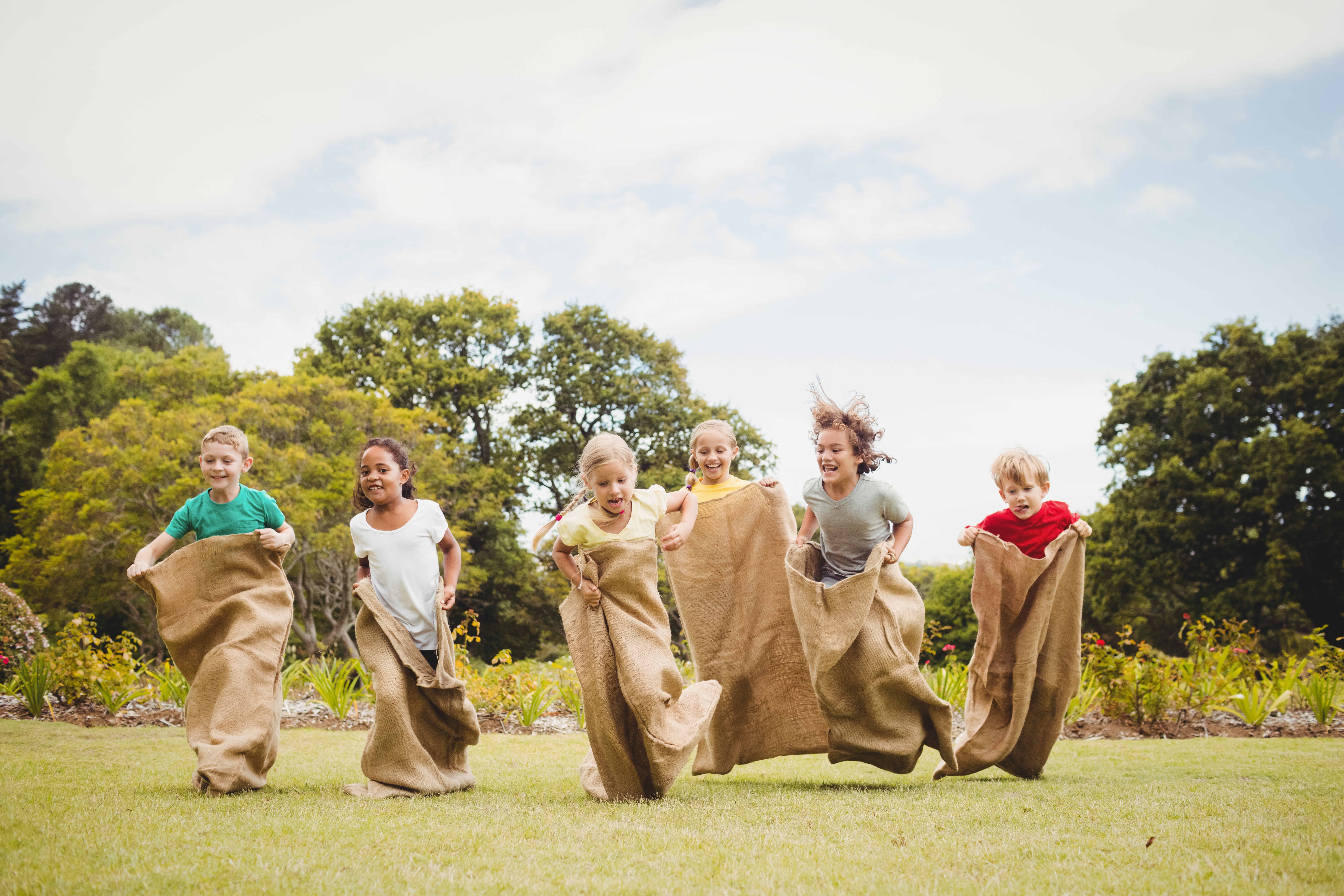 Children enjoying the sack race on sports day.