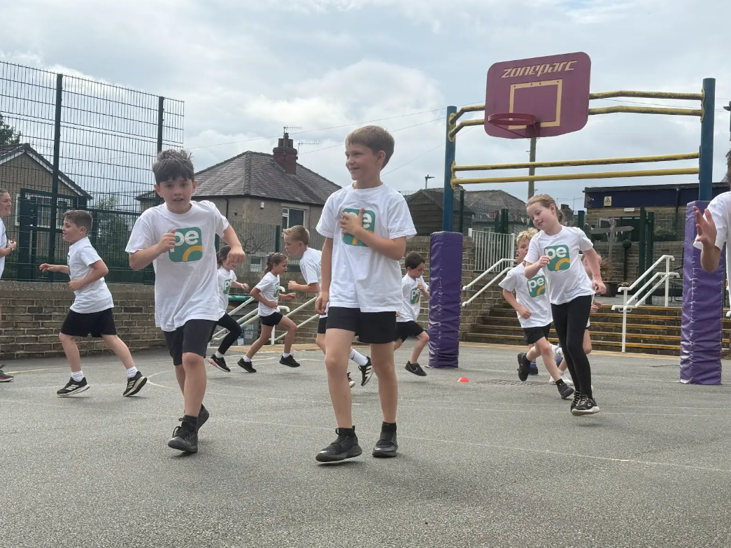 Primary school children playing a PE warm up game