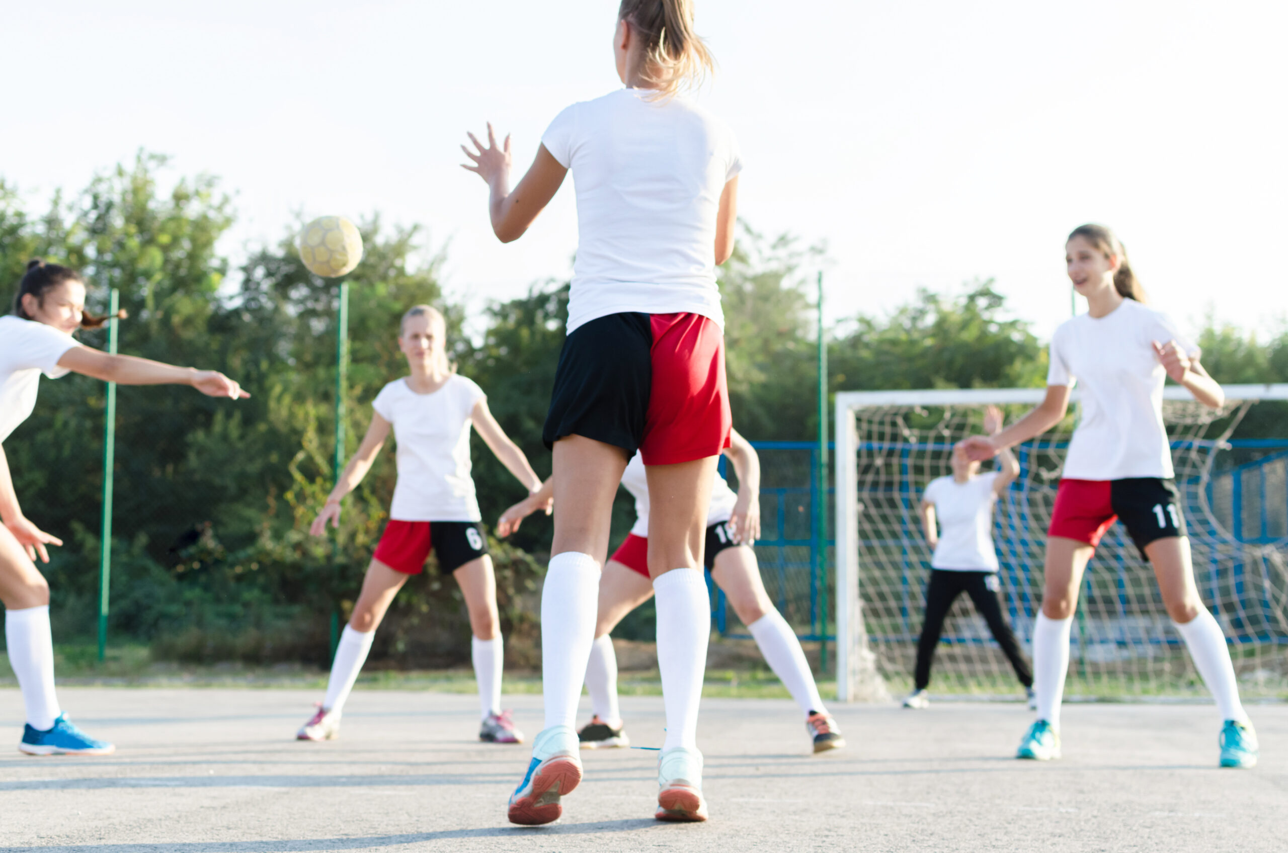 Primary School PE invasion sports being played on the playground